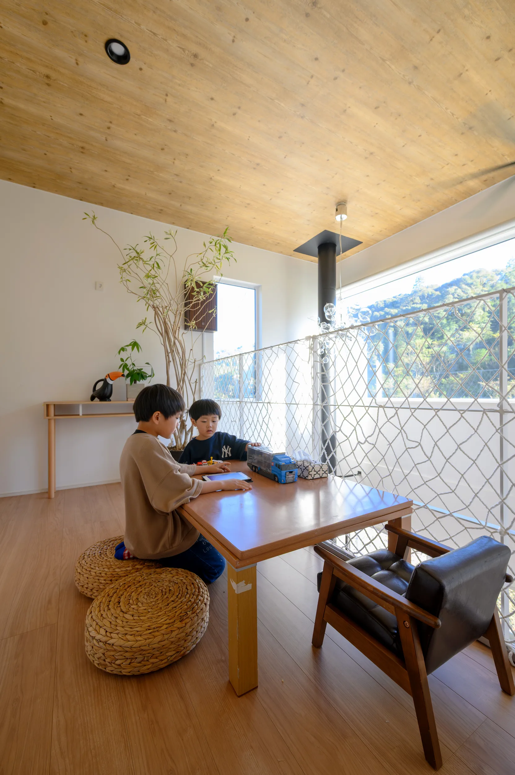 吹き抜けに面した2階ホール。窓辺のテーブルで食事を楽しむことも